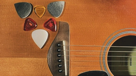 guitar picks on acoustic guitar